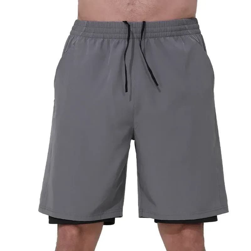 man wearing grey 2 in 1 gym shorts with black liner, front view