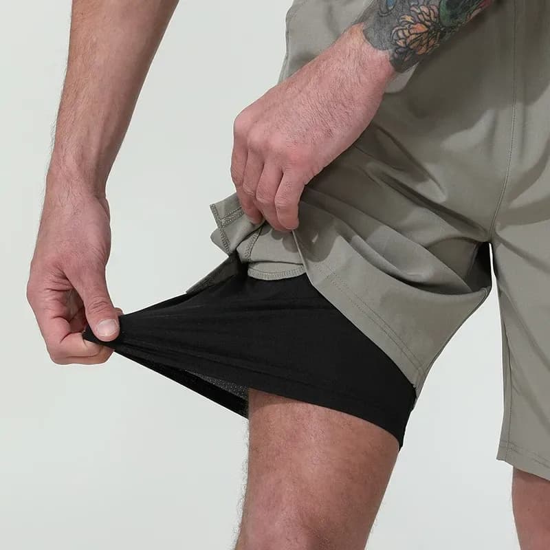 hand pulling the stretch inner liner of the 2 in 1 gym shorts