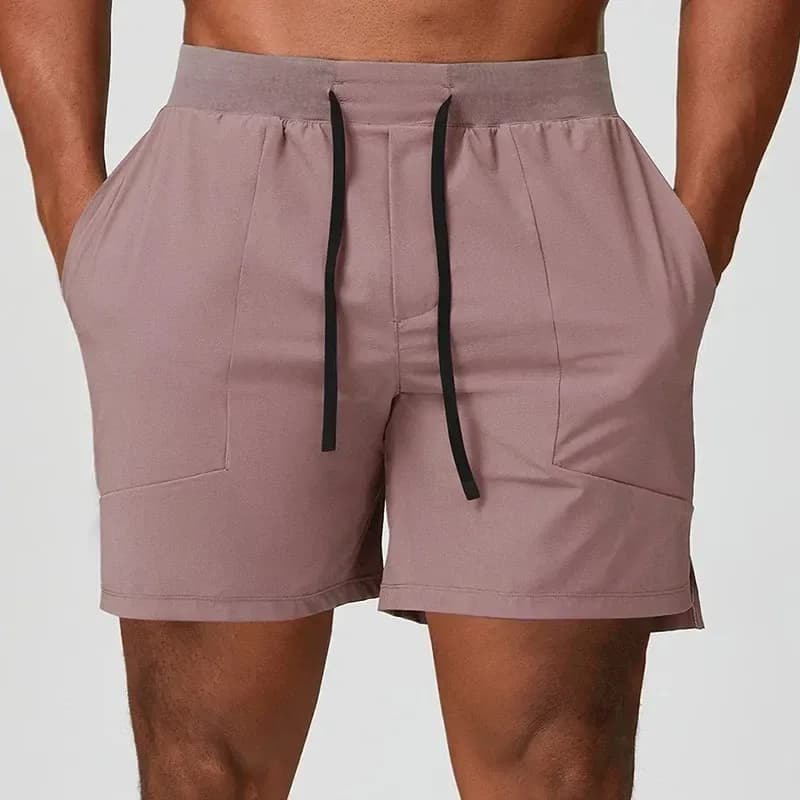 man wearing dusty pink stretch training shorts