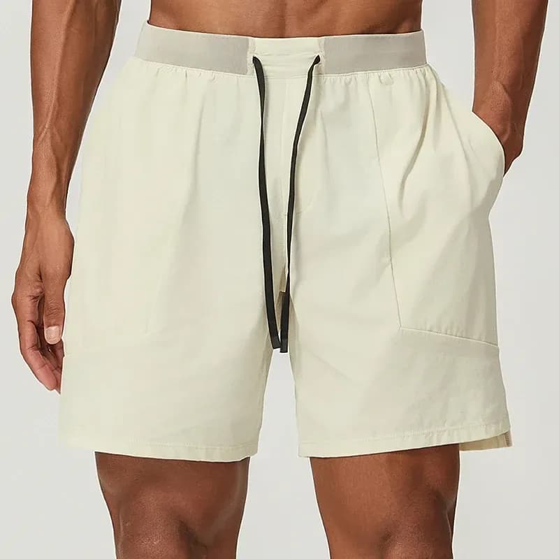 man wearing light apricot stretch training shorts