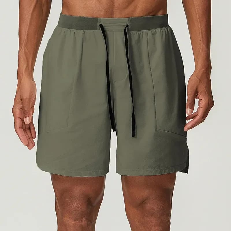 man wearing olive grey stretch training shorts with drawstring