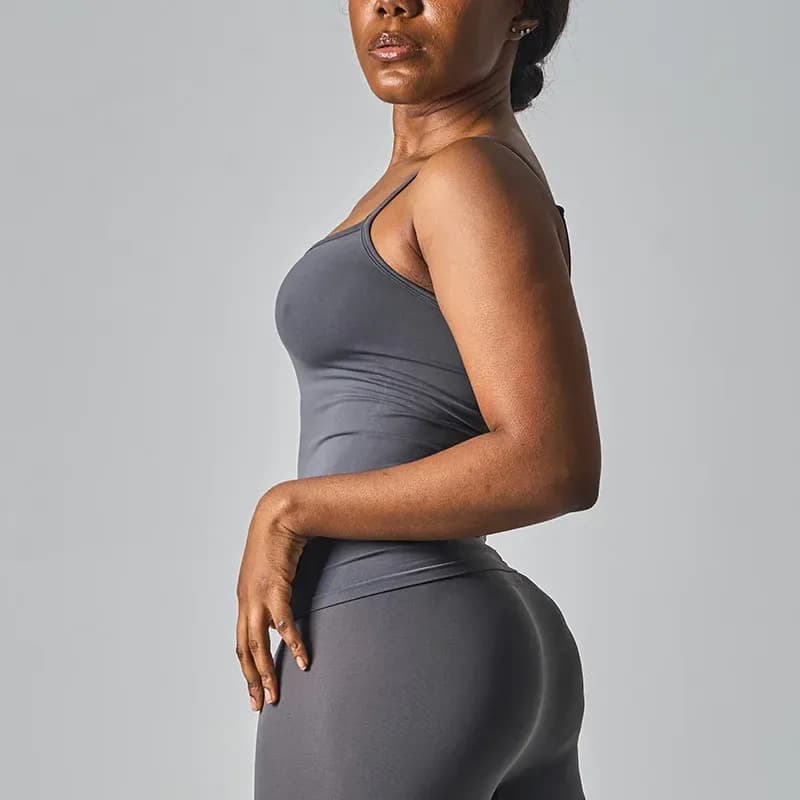 back view of a grey seamless workout tank top with thin straps