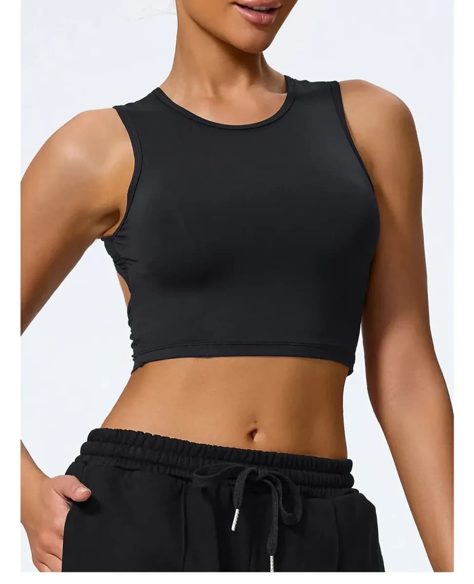 woman wearing a black open back crop tank top with crew neck, front view