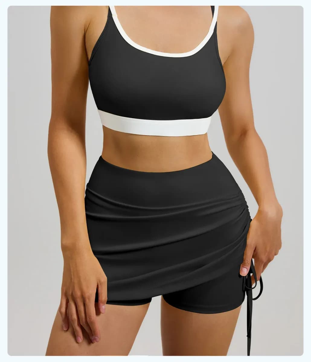 black ruched high waisted skort worn with a sports bra, front view