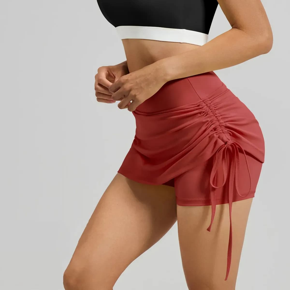red ruched high waisted skort, side view showing the drawstring