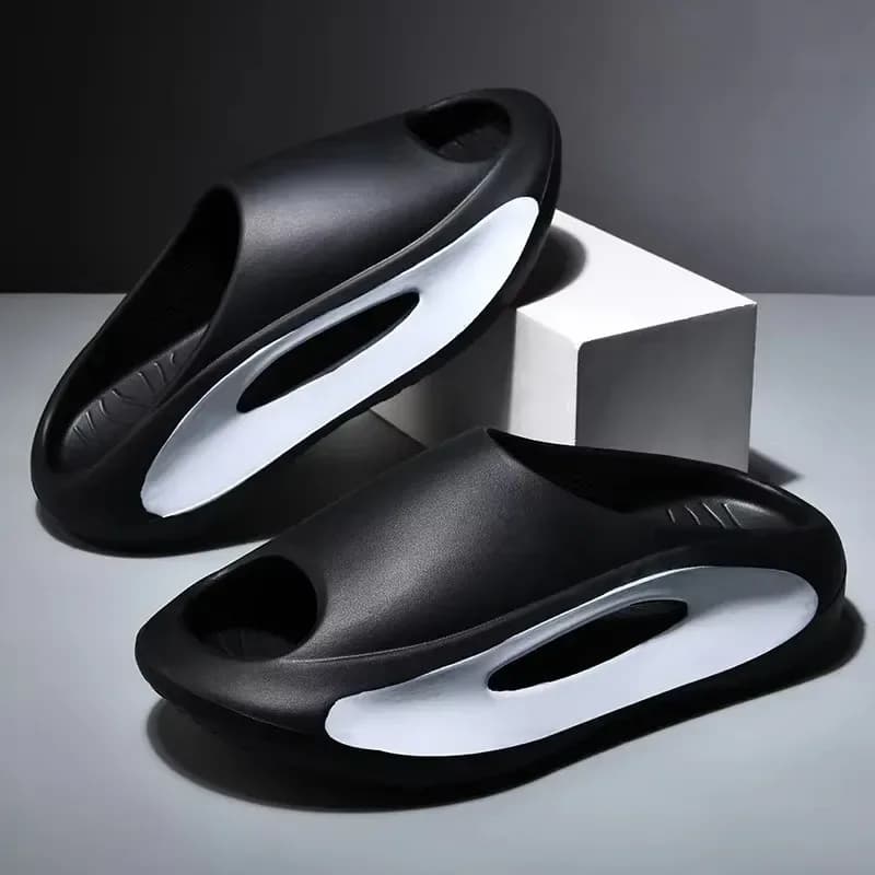 pair of black thick platform eva slides with white cutout