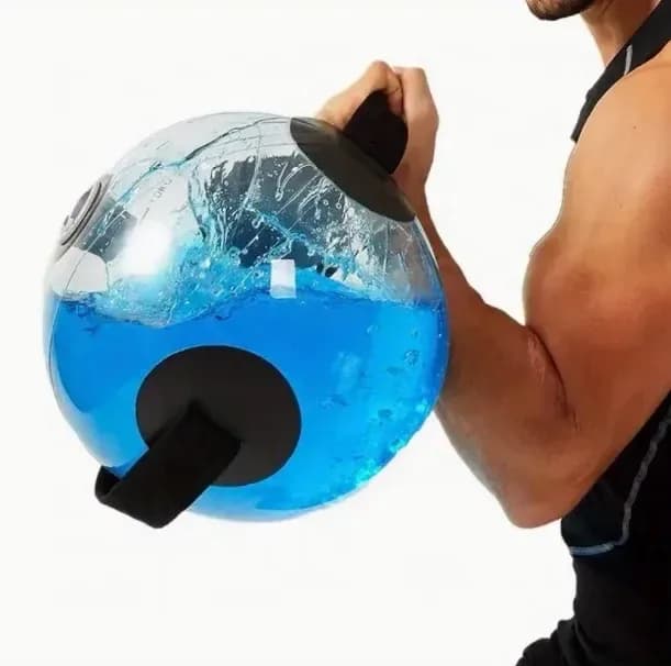 man lifting a water filled training ball with handles