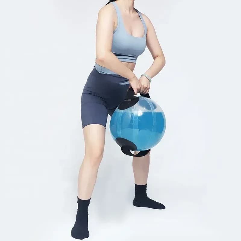 woman holding a water filled training ball between her legs for a squat