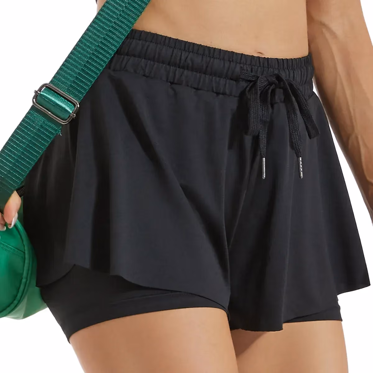 woman wearing black flowy 2 in 1 running shorts with drawstring waist