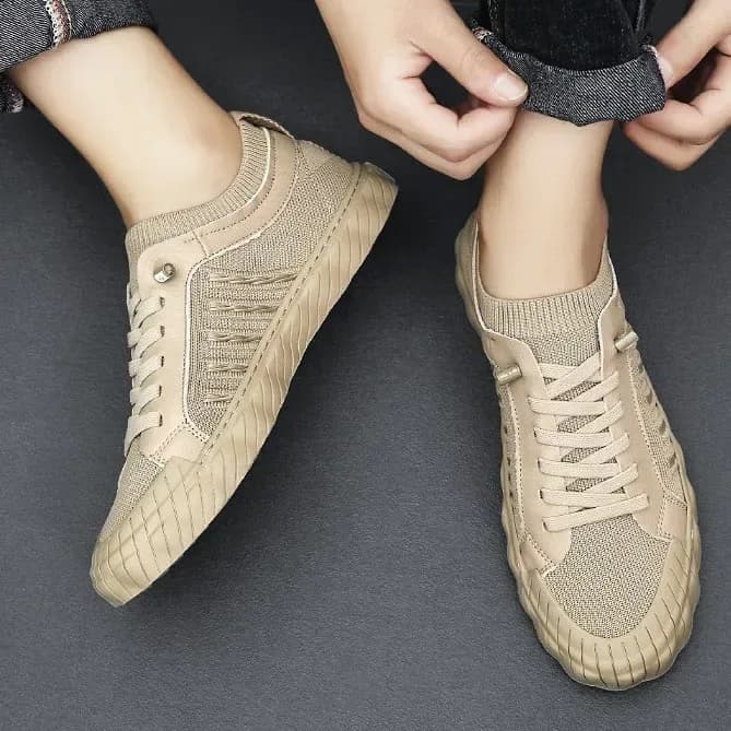 man wearing beige lightweight mesh sneakers, top view